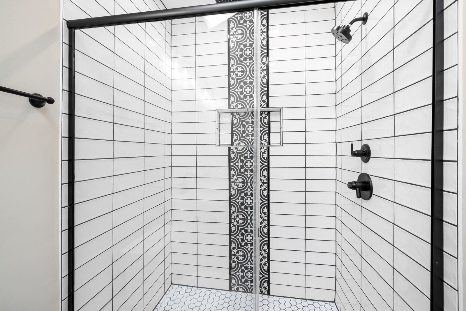 Walk-in tiled shower with glass door