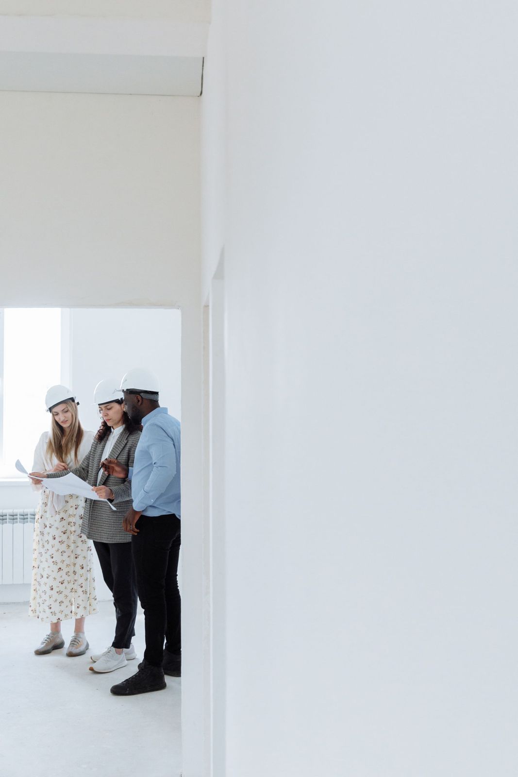 Contractor reviewing plans inside an empty rental property